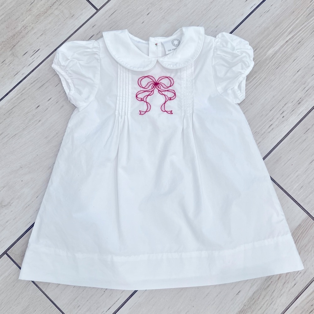 White dress with red bow embroidery